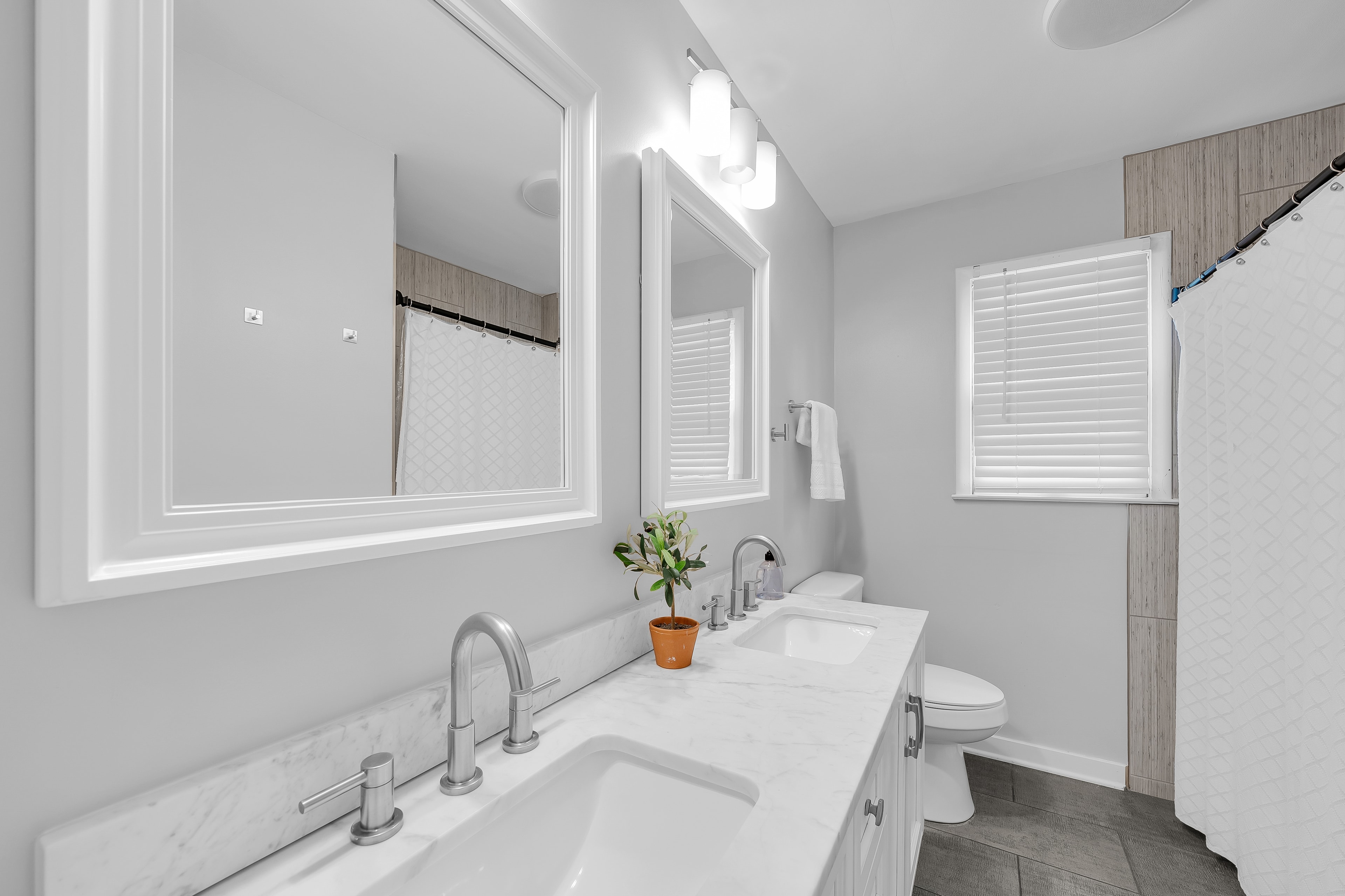 RCVRY HOUSE shared bathroom double vanity close-up with mirrors