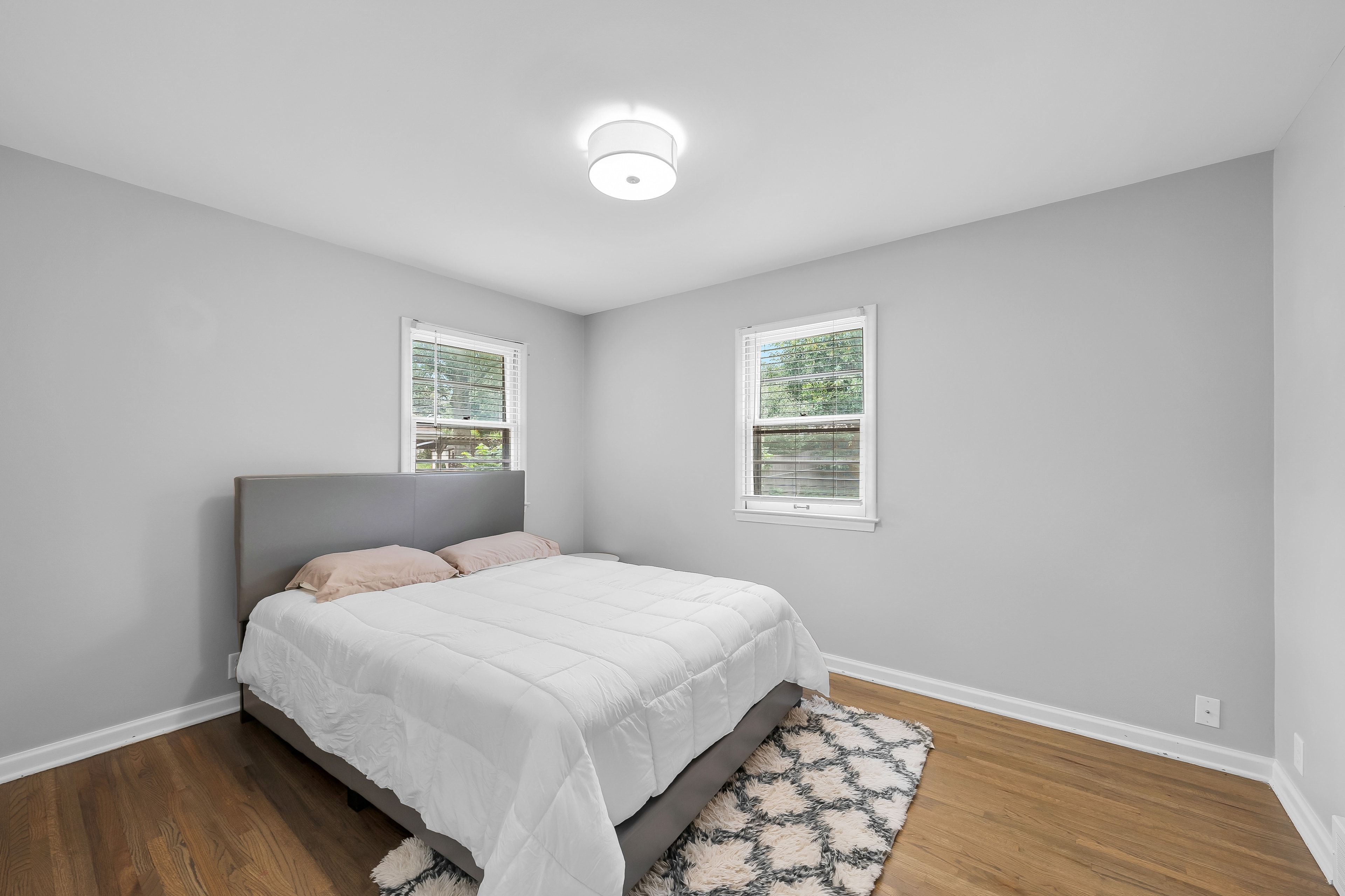 RCVRY HOUSE bedroom with two windows and minimal furnishings