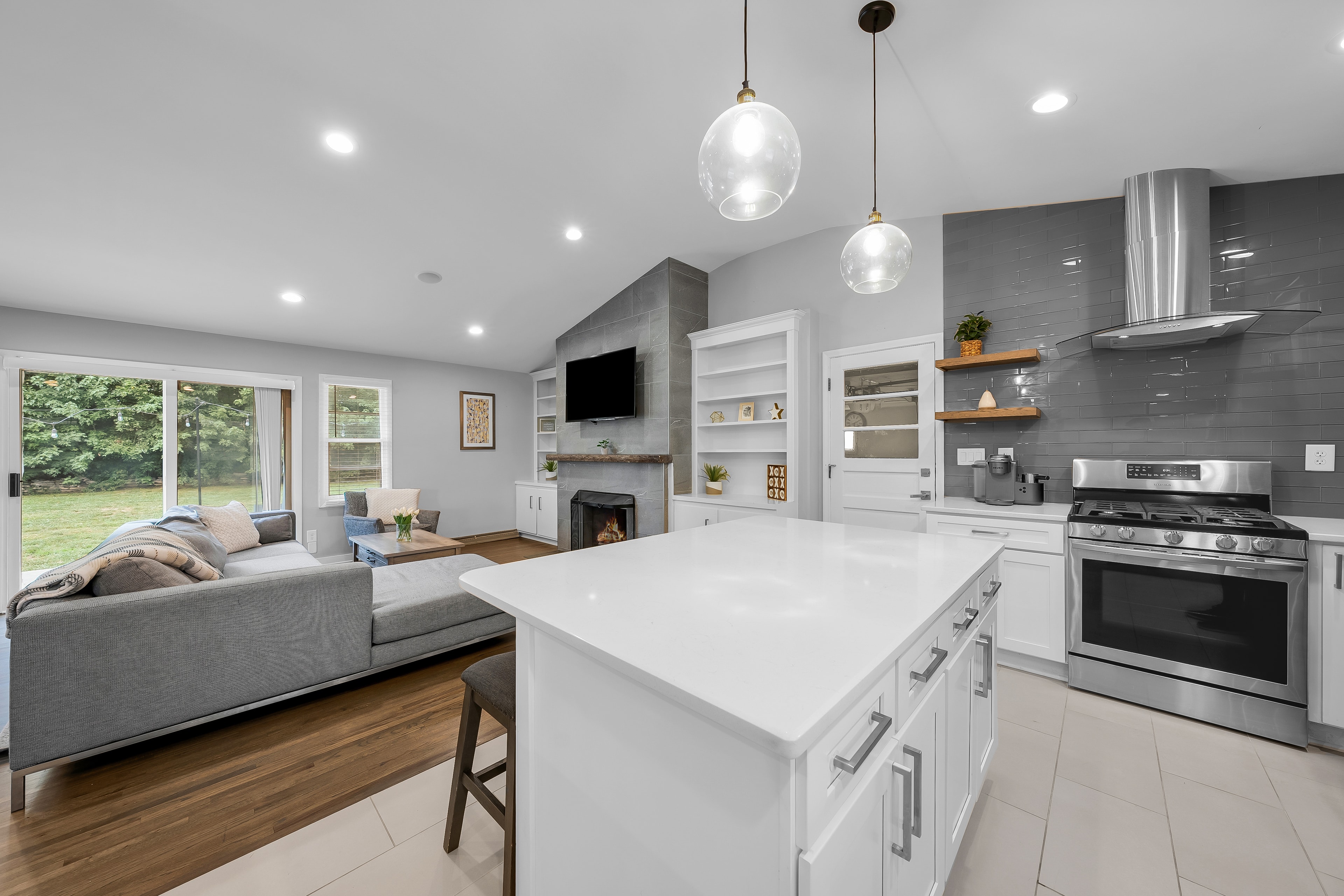 RCVRY HOUSE kitchen island and living room fireplace — wide angle