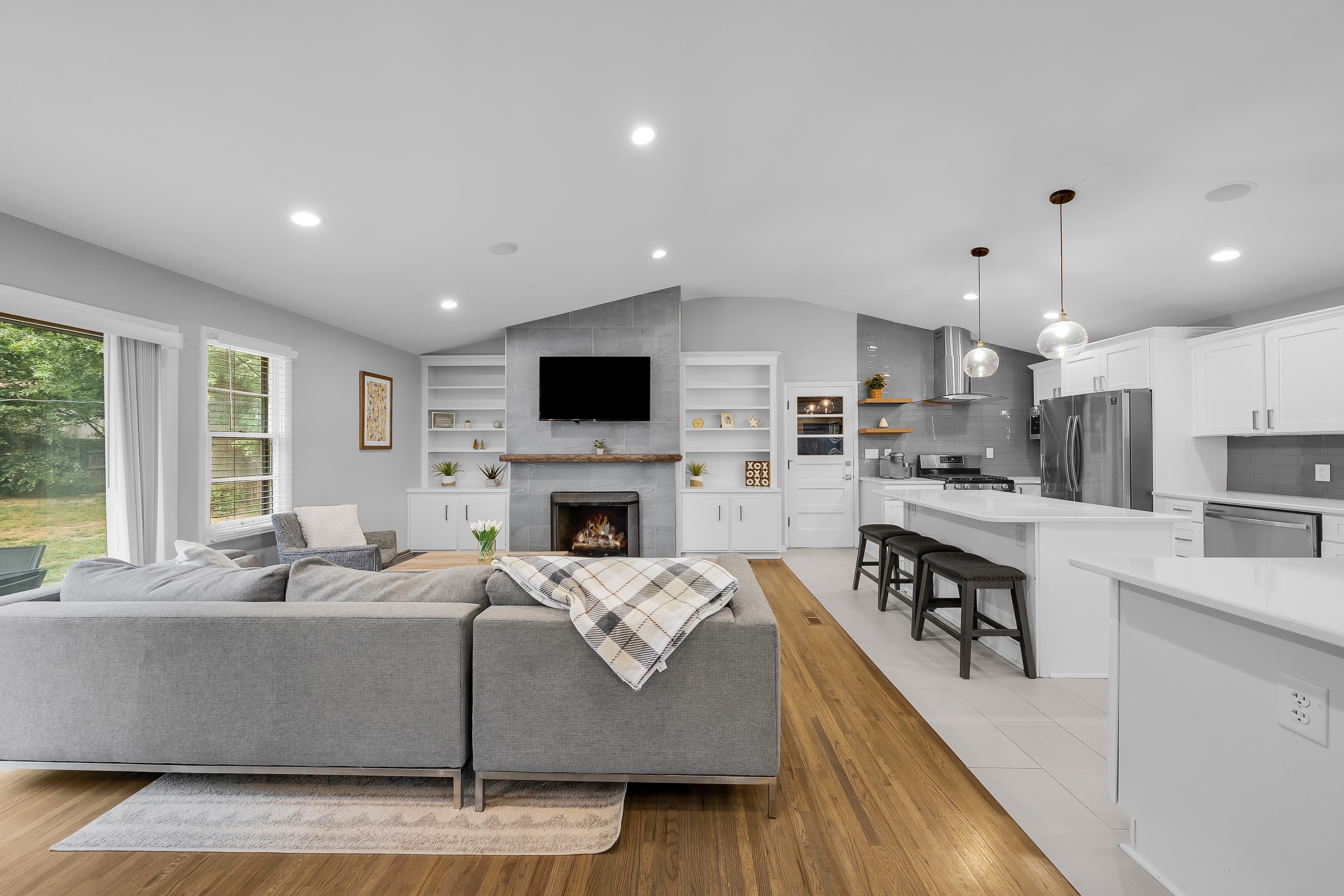 RCVRY HOUSE living room and kitchen with island bar stools centered