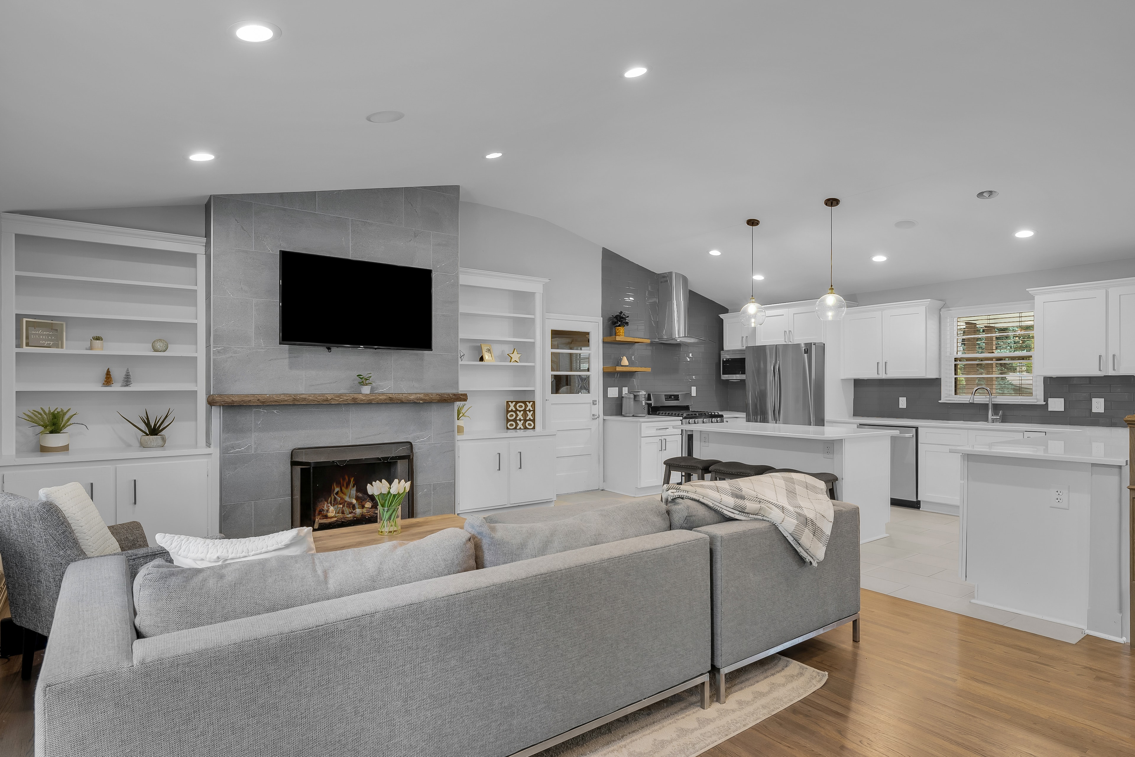 RCVRY HOUSE living room and kitchen with fireplace centered