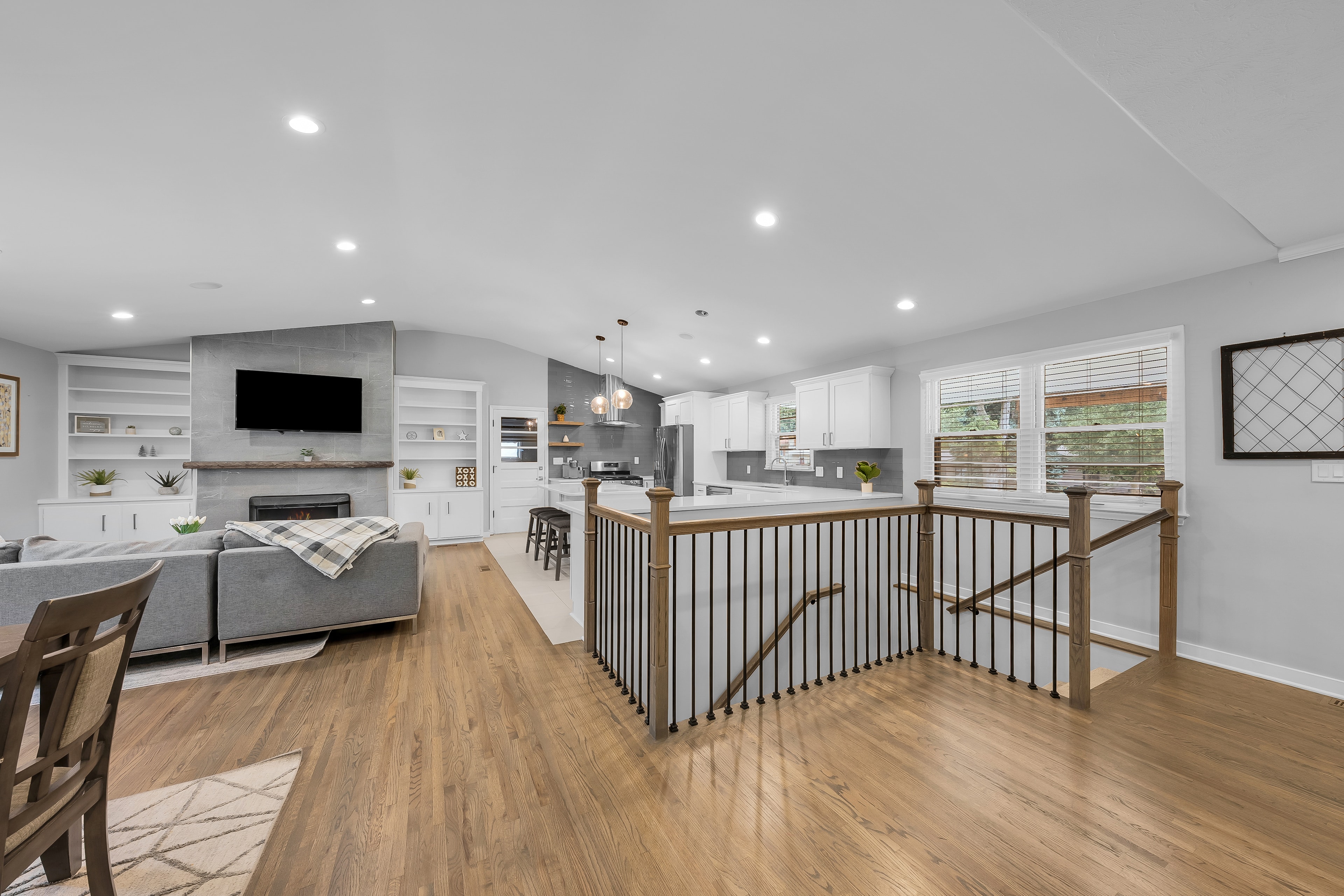 RCVRY HOUSE open floor plan from staircase landing — full living and kitchen view